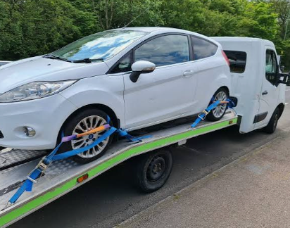 Vehicle being safely recovered on a flatbed truck